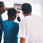 Three Person Looking at X-ray Result